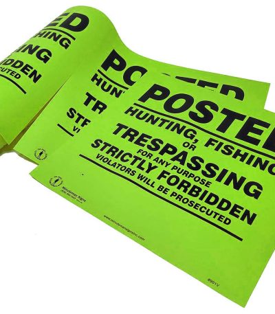posted no trespassing sign on a roll lime green