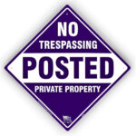 purple posted no trespassing sign